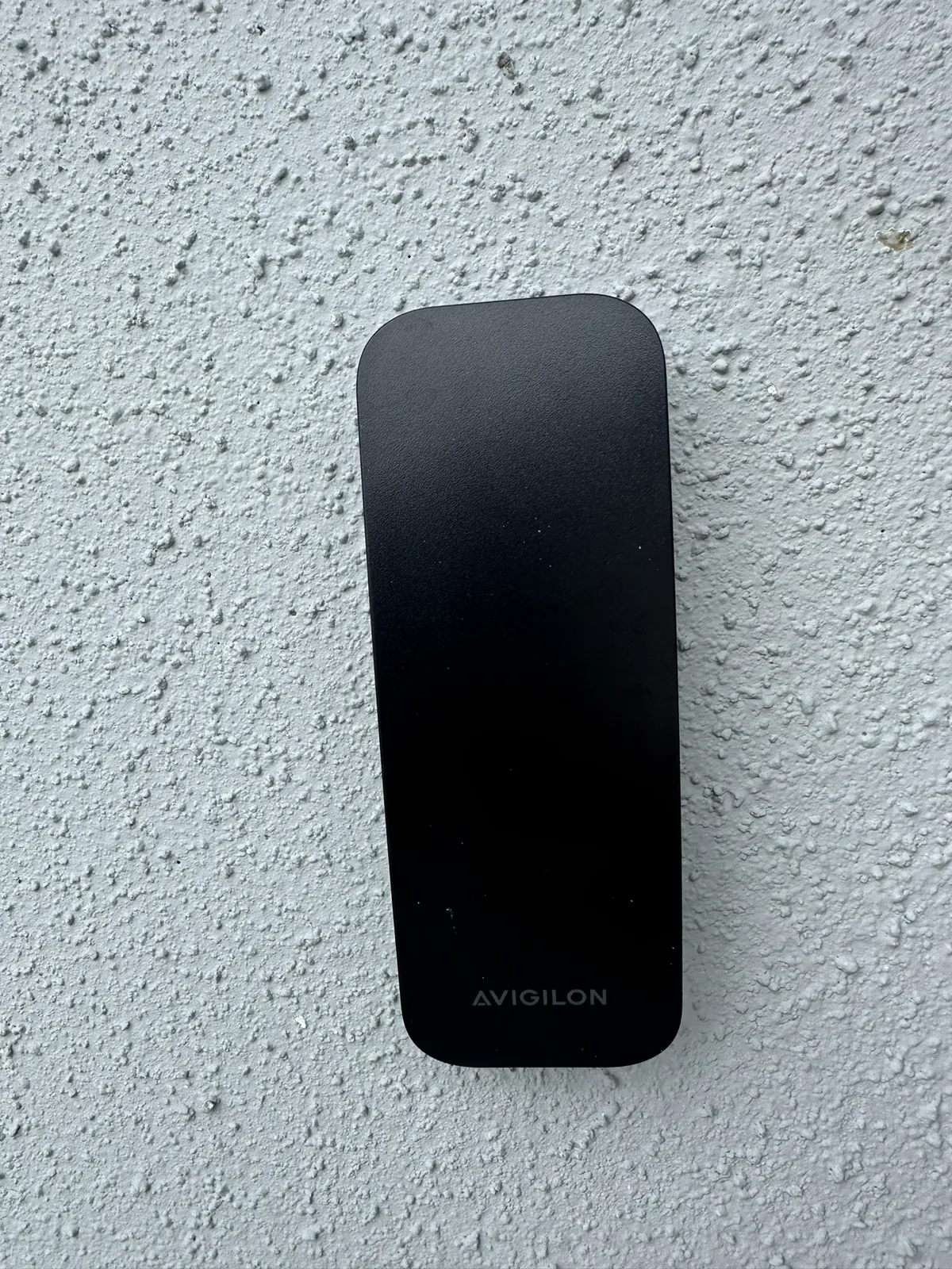 Slim access card reader mounted on a textured exterior wall at a Data Pro Communications project in Orlando, FL