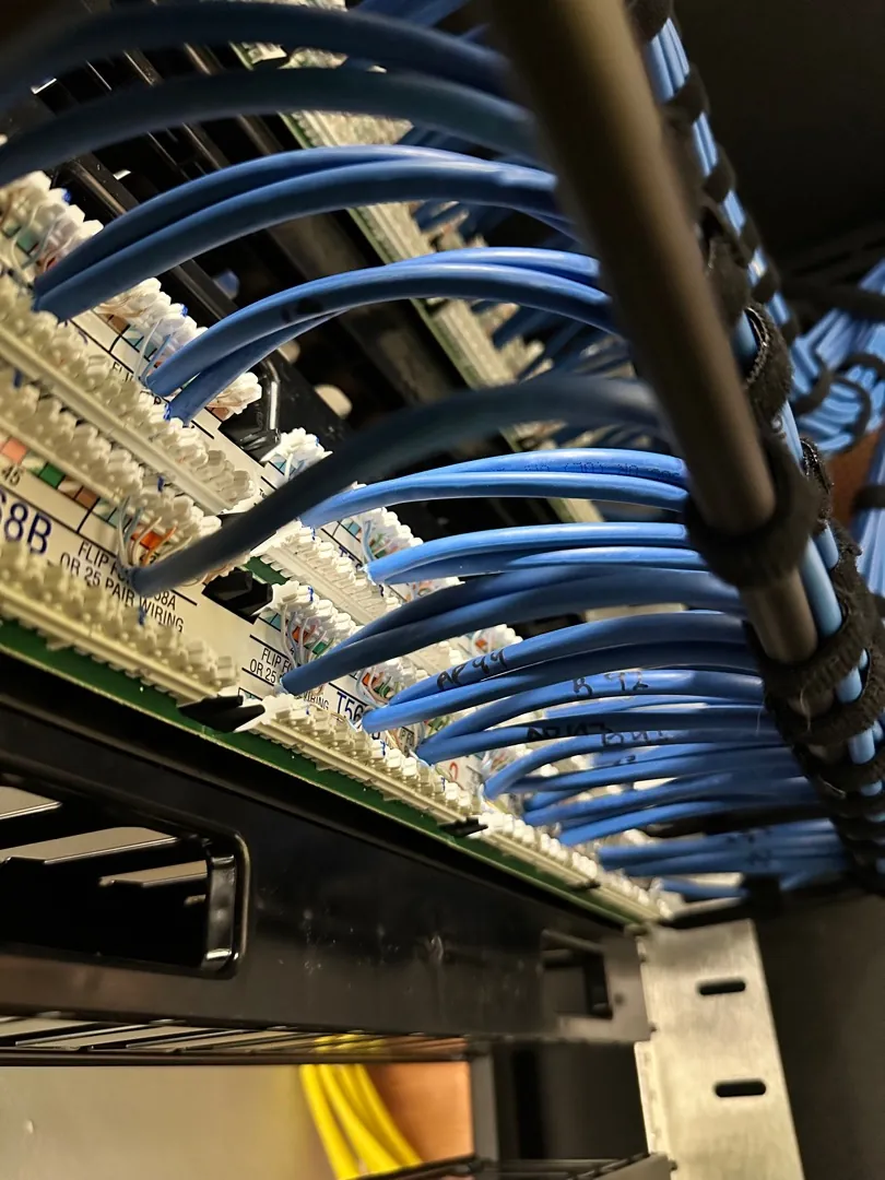 Close-up of patch panel terminations and vertical cable management at a Data Pro Communications project in Orlando, FL