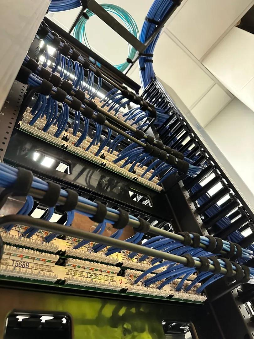 Rack patch panels and horizontal cable managers viewed from below at a Data Pro Communications project in Orlando, FL