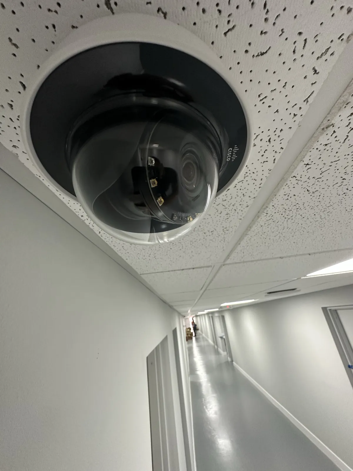 Ceiling-mounted dome camera covering a long interior corridor at a Data Pro Communications project in Orlando, FL