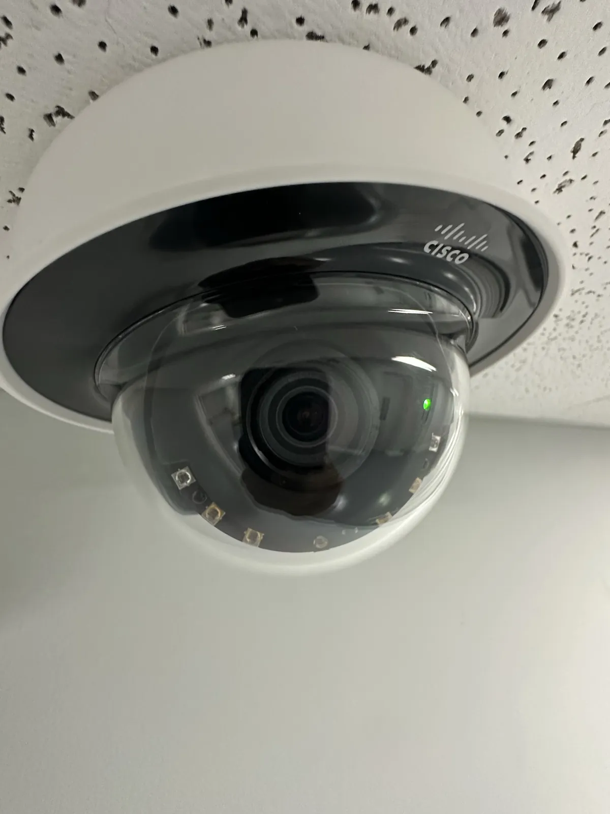 Close-up of an interior dome camera in an acoustic tile ceiling at a Data Pro Communications project in Orlando, FL