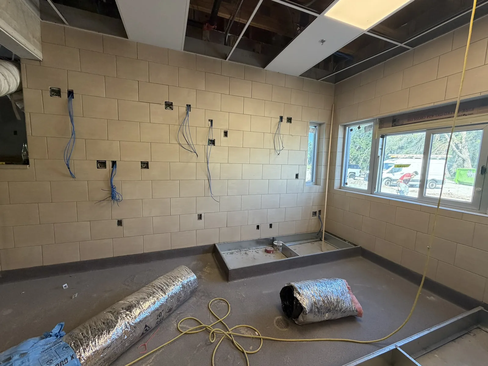 Multiple cable runs along commercial walls during build-out at a Data Pro Communications project in Orlando, FL