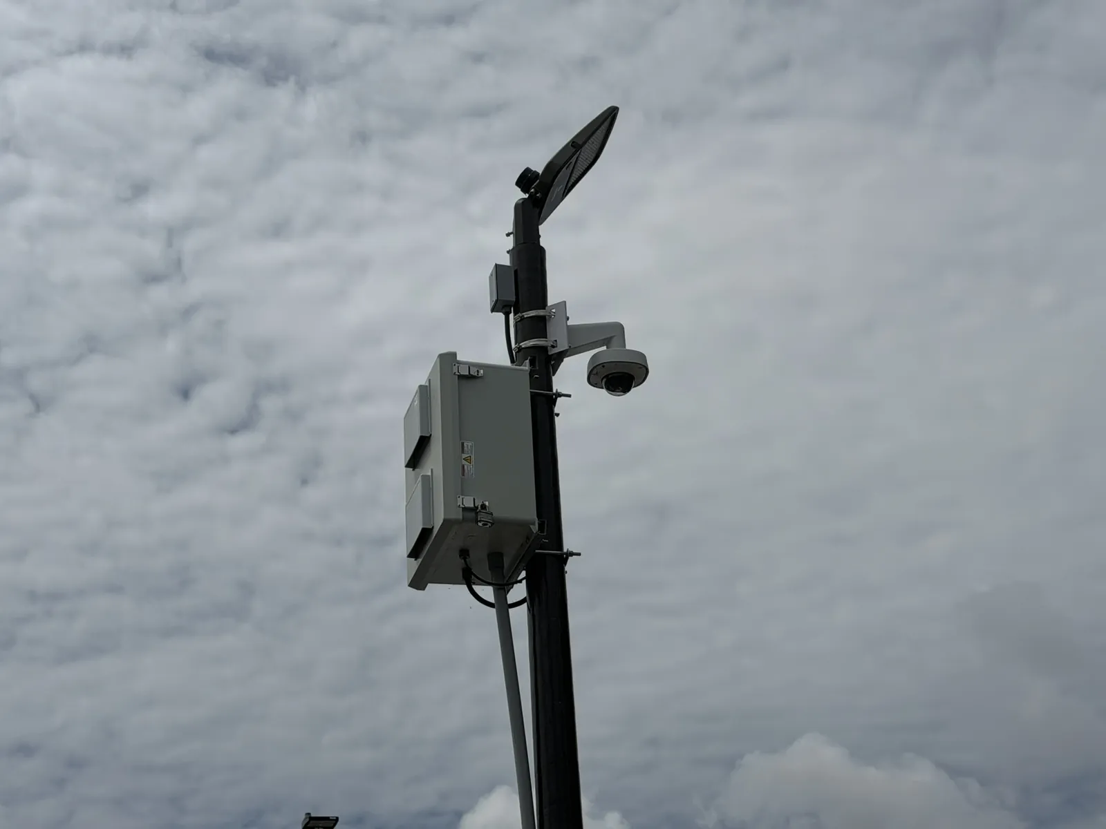 Pole-mounted camera and equipment enclosure at an exterior site at a Data Pro Communications project in Orlando, FL