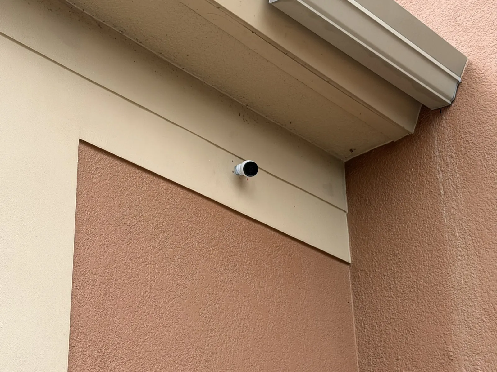 Exterior commercial security camera under a building eave at a Data Pro Communications project in Orlando, FL