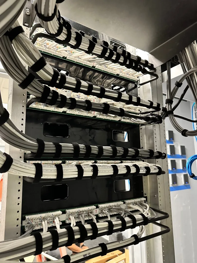 Rack with dressed white patch cords and horizontal cable managers at a Data Pro Communications project in Orlando, FL