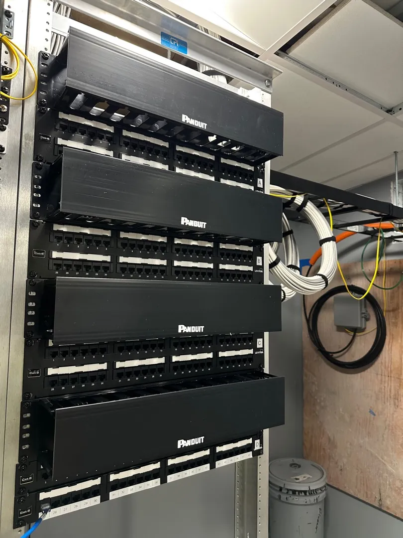 Patch panel rack with cable managers and fiber slack at a Data Pro Communications project in Orlando, FL