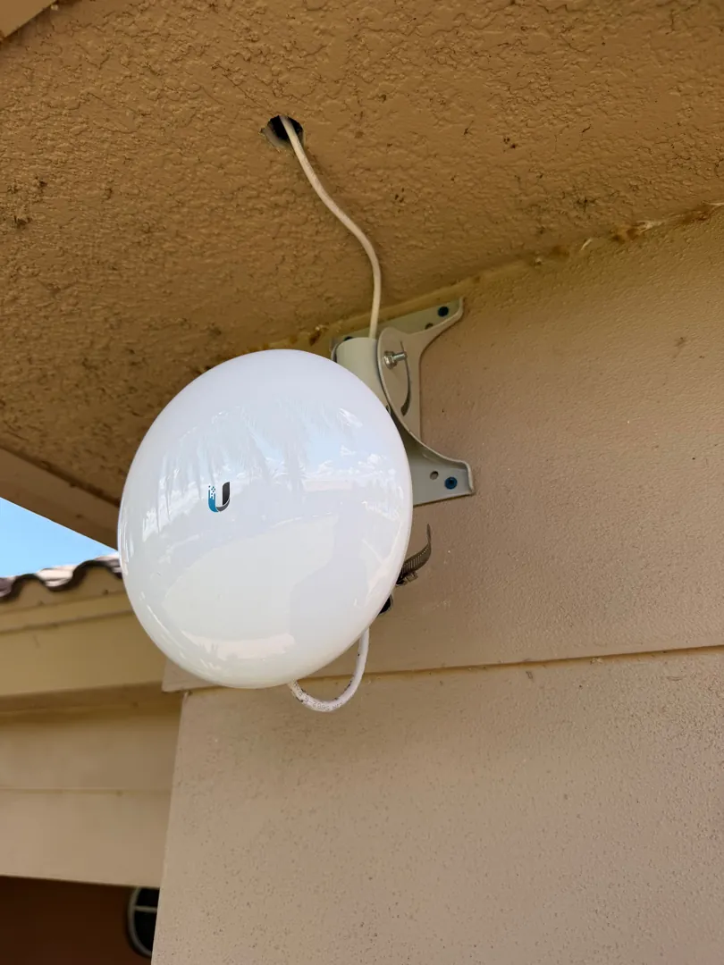 airMAX NanoStation PtP antenna on eave at a Data Pro Communications project in Groveland, FL