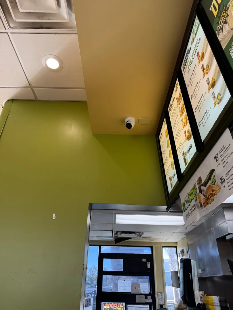 Front counter w/ dome camera & menu boards (brand) at a Data Pro Communications project in Orlando, FL