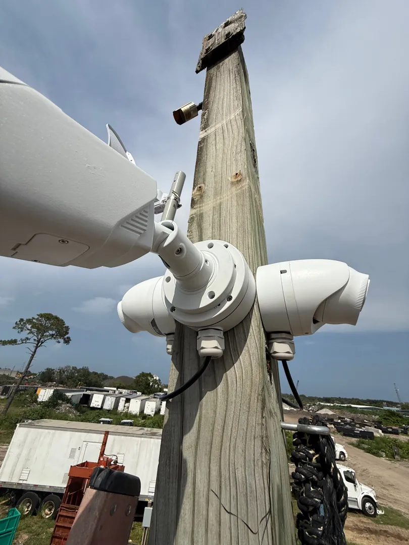 Wireless bridge and cameras on a yard pole at a Data Pro Communications project in Apopka, FL